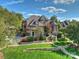 Stunning brick home featuring professional landscaping, stone accents, and a charming stone stairway to the front entrance at 7311 Barrington Ridge Dr, Fort Mill, SC 29707