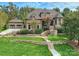 Beautiful brick home with an attached garage, lush landscaping, and a stone walkway leading to the front door at 7311 Barrington Ridge Dr, Fort Mill, SC 29707