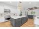 Bright, open kitchen with stainless steel appliances, large island, white cabinets, and a wood floor at 7311 Barrington Ridge Dr, Fort Mill, SC 29707