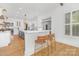 An open kitchen featuring a breakfast bar with seating and custom cabinets at 7311 Barrington Ridge Dr, Fort Mill, SC 29707