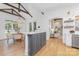 An open space including kitchen and dining area featuring vaulted ceilings and exposed beams at 7311 Barrington Ridge Dr, Fort Mill, SC 29707