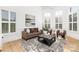 Cozy living room featuring large windows, stylish furniture, and a chic area rug, perfect for relaxation and entertaining at 7311 Barrington Ridge Dr, Fort Mill, SC 29707