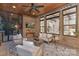 Inviting screened-in patio with brick walls, comfortable seating, ceiling fan, and a view to the outdoors at 7311 Barrington Ridge Dr, Fort Mill, SC 29707