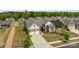 Expansive aerial view of home showcasing a two-car garage, and lush surroundings in a desirable neighborhood at 8018 Green Heron Ct, Belmont, NC 28012