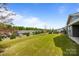 Beautiful backyard featuring a lush green lawn and views of surrounding homes in a well-kept neighborhood at 8018 Green Heron Ct, Belmont, NC 28012