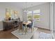Dining area includes a stylish chandelier, bar, and large windows offering natural light at 8018 Green Heron Ct, Belmont, NC 28012