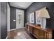 Inviting entryway with wood floors, dark walls, stylish console table, and decorative artwork at 8018 Green Heron Ct, Belmont, NC 28012