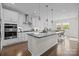 Stylish kitchen with white cabinetry, stainless steel appliances, and a center island overlooking the dining area at 8018 Green Heron Ct, Belmont, NC 28012