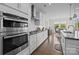 Bright kitchen boasts stainless steel appliances, white cabinetry, and a view into the dining area at 8018 Green Heron Ct, Belmont, NC 28012