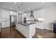 Modern kitchen with white cabinets, stainless steel appliances, and a large island at 8018 Green Heron Ct, Belmont, NC 28012