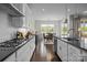 Open kitchen features modern white cabinets, stainless steel appliances, and breakfast bar at 8018 Green Heron Ct, Belmont, NC 28012