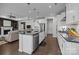Spacious open kitchen featuring white cabinets, stainless appliances, island and view of the living area at 8018 Green Heron Ct, Belmont, NC 28012