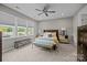 Serene main bedroom with large windows, ceiling fan, and neutral color scheme at 8018 Green Heron Ct, Belmont, NC 28012