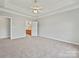 Neutral bedroom offers carpet, ample natural light, and ceiling fan at 8274 Windsor Ridge Dr, Charlotte, NC 28277