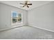 Neutral bedroom features natural light, carpet and a ceiling fan at 8274 Windsor Ridge Dr, Charlotte, NC 28277