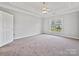 Spacious bedroom with neutral carpet, ample natural light, and ceiling fan at 8274 Windsor Ridge Dr, Charlotte, NC 28277