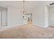 Open-concept dining area featuring a modern chandelier and access to kitchen at 8274 Windsor Ridge Dr, Charlotte, NC 28277