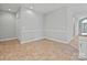 Bright dining area features tile floors, neutral walls, and wainscoting at 8274 Windsor Ridge Dr, Charlotte, NC 28277