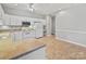 Open-concept kitchen boasts white appliances, ample counter space, and tile flooring at 8274 Windsor Ridge Dr, Charlotte, NC 28277