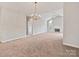Living room featuring a fireplace, large window, and view into another room at 8274 Windsor Ridge Dr, Charlotte, NC 28277