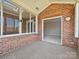 Bright sunroom features brick accents, large windows, and neutral carpet at 8274 Windsor Ridge Dr, Charlotte, NC 28277