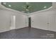 Spacious bedroom with sleek gray flooring, green accent wall visible through doorway, and modern recessed lighting at 856 Driftwood Rd, Lincolnton, NC 28092