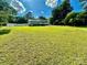Large backyard with a house, deck, and vehicle at 9007 Mcmillian Dr, Harrisburg, NC 28075