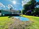 Spacious backyard with an in-ground pool, a house, and a commercial truck at 9007 Mcmillian Dr, Harrisburg, NC 28075