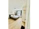 Serene bedroom with a gray upholstered bed, wood floors, and minimalist decor for a relaxing atmosphere at 9007 Mcmillian Dr, Harrisburg, NC 28075