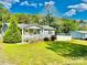 Cozy single-story house with a white picket fence and a lush green lawn, perfect for outdoor enjoyment at 9007 Mcmillian Dr, Harrisburg, NC 28075