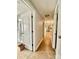 Hallway with wood floors leading to a bathroom and kitchen at 9007 Mcmillian Dr, Harrisburg, NC 28075