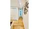 Bright hallway with stylish wood flooring, leading to additional rooms and featuring unique decor at 9007 Mcmillian Dr, Harrisburg, NC 28075