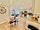 Open-concept kitchen and living room with stainless steel appliances, wood floors, and cozy breakfast nook at 9007 Mcmillian Dr, Harrisburg, NC 28075