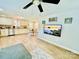 Bright living room and kitchen area with stainless steel appliances, wood floors, and natural light at 9007 Mcmillian Dr, Harrisburg, NC 28075