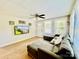 Inviting living room featuring hardwood floors, a comfortable sectional, and ample natural light from large windows at 9007 Mcmillian Dr, Harrisburg, NC 28075
