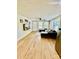 Bright living room with hardwood floors, a ceiling fan, and a comfortable sectional sofa by the windows at 9007 Mcmillian Dr, Harrisburg, NC 28075