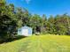View of a well-kept shed for storage and a verdant backyard at 9007 Mcmillian Dr, Harrisburg, NC 28075