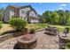 Home backyard featuring a dining set, patio, a fire pit, and landscaped yard at 9494 Leyton Dr, Harrisburg, NC 28075