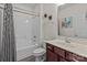 Bathroom with a combined shower and tub unit, featuring modern fixtures and bright lighting at 9494 Leyton Dr, Harrisburg, NC 28075
