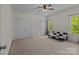 Bright bedroom with a modern futon, two closets, and large windows offering natural light at 9494 Leyton Dr, Harrisburg, NC 28075
