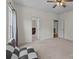Spacious bedroom with a checkered futon, neutral walls, and multiple doorways at 9494 Leyton Dr, Harrisburg, NC 28075