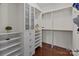 Organized walk-in closet with custom shelves, drawers, and hanging rods for ample storage at 9494 Leyton Dr, Harrisburg, NC 28075