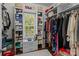 Well-organized walk-in closet with custom shelving, hanging space, and a window for natural light at 9494 Leyton Dr, Harrisburg, NC 28075