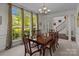 Bright dining room with a large window, elegant chandelier, and traditional furnishings at 9494 Leyton Dr, Harrisburg, NC 28075