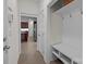 Entryway with white bench, shelf, and hooks, leading to the kitchen and other areas of the home at 9494 Leyton Dr, Harrisburg, NC 28075