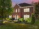 Charming two-story brick home with landscaped front yard and double-door entry, perfect for a welcoming curb appeal at 9494 Leyton Dr, Harrisburg, NC 28075