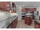 Gourmet kitchen with stainless steel appliances, granite countertops, and custom cabinetry at 9494 Leyton Dr, Harrisburg, NC 28075