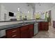 Large kitchen with stainless steel sink, granite countertops, and a view to the adjacent living room at 9494 Leyton Dr, Harrisburg, NC 28075