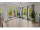 Bright sunroom featuring large windows, tile flooring, and access to an outdoor deck at 9494 Leyton Dr, Harrisburg, NC 28075