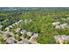 Aerial view of a neighborhood surrounded by lush greenery and mature trees at 9810 Daufuskie Dr, Charlotte, NC 28278